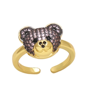 Detailed macro shot of a golden teddy bear ring with purple and pink pavé zirconia