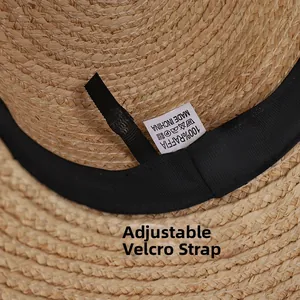 Detail of raffia straw hat showing internal sweatband and adjustable velcro strap