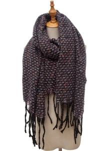 Detail of dark knitted scarf featuring colorful flecks and soft black fringe texture
