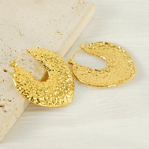 Textured 18K gold plated chunky hoop earrings with a hammered finish and retro style