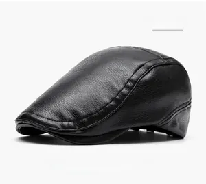 Detail of black faux leather beret featuring lychee texture and reinforced stitching