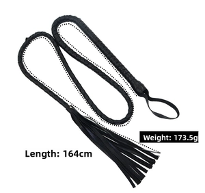 Close-up of 164cm black braided leather whip with wrist strap and tassel detail