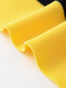 Detailed macro view of vibrant yellow ribbed knit fabric texture and elastic weave material