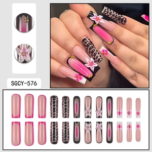 Long coffin press-on nails with 3D white flower motifs and pink marble patterns