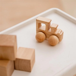 Close-up of a smooth walnut wooden toy train car for early childhood development
