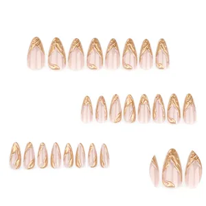 3D gold flame design on almond short press-on nails with a soft nude pink base
