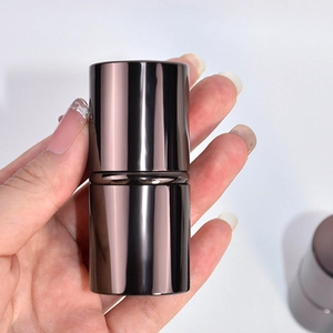 Close-up of portable retractable makeup brush with coffee bronze metallic finish