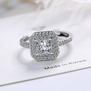 Luxurious square halo ring with radiant cut center stone and pave-set diamond band