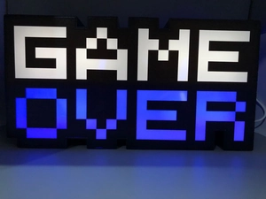 Detail of pixel style GAME OVER LED lamp with white and blue neon lighting effects