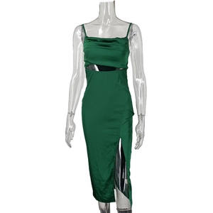 Detail of green satin dress featuring high side slit and hollow-out chest design