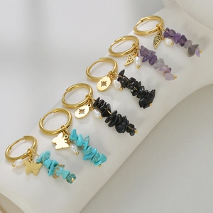 Three pairs of 14k gold earrings with butterfly star wing charms and natural stones