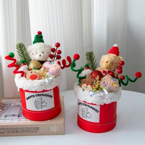 Detailed close-up of a Christmas plush bear bouquet in a festive red gift bucket