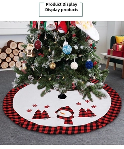 Detail of red and black plaid Christmas tree skirt with snowman and tree embroidery