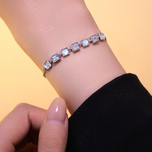 Chic silver bracelet with square cat-eye and zircon stones on a model's wrist