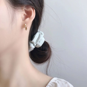 Elegant S925 sterling silver gold plated diamond huggie earring on model's ear