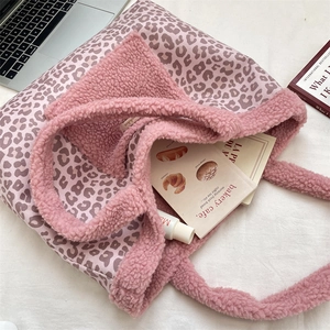 Detailed overhead view of a pink leopard print plush tote bag with fuzzy lamb wool trim