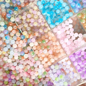 Colorful 8mm frosted glass beads stored in a transparent organizer box for DIY jewelry