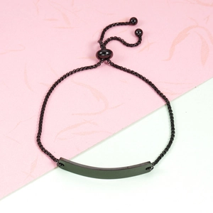 Detail of adjustable black woven rope bracelet with matte curved metal ID bar