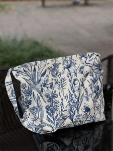 Detail of vintage blue plant pattern on large canvas tote bag with wide shoulder strap