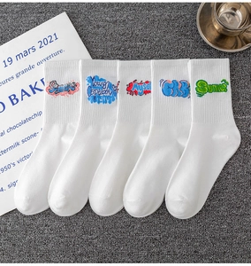 Detail of five pairs of white cotton socks with vibrant street style graffiti embroidery
