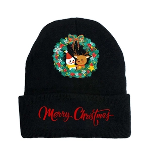 Detail of a black knit winter beanie with red Merry Christmas print and festive icons