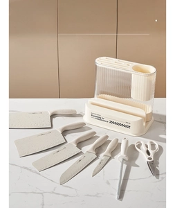 Detail of cream kitchen organizer showing knife slots and transparent utensil holder