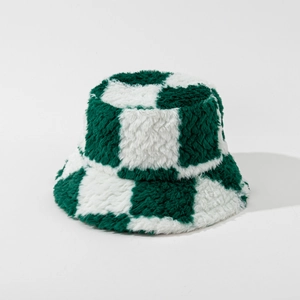 Detailed close-up of dark green and cream checkerboard plush texture on a bucket hat