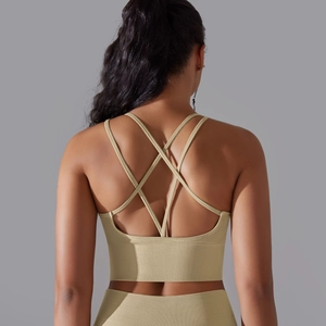 Detail of light beige ribbed sports bra featuring a crisscross strappy back design