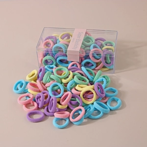 Detail of multi-color high elasticity hair ties set in a clear storage box