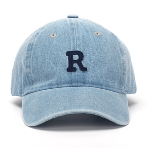 Macro detail of R embroidery on vintage washed light blue denim baseball cap