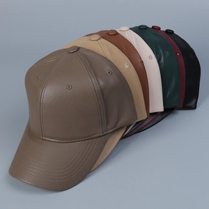 Detailed view of PU leather baseball caps showing lychee texture and fine stitching