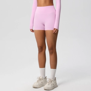 Close-up of pink high-waisted yoga shorts with elastic fabric for fitness and running