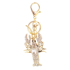 Sparkling gold lobster keychain with white rhinestones and large oval crystal pendant