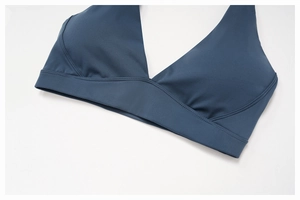Detailed close-up of V-neck sports bra with wide band and reinforced stitching