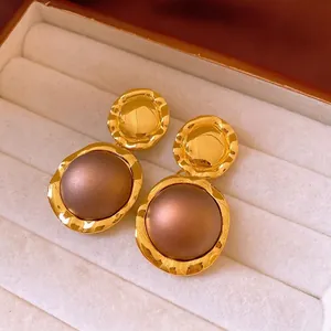 Vintage gold hammered earrings with brown center inlay in cream jewelry box