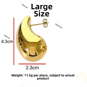 Polished gold teardrop earring detail showing glossy finish and 4.3cm large size