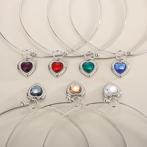 Detailed flat lay of stainless steel bangles with colorful heart-shaped glass stones
