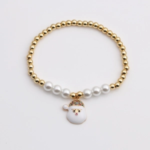 Christmas themed beaded bracelet featuring gold metal beads pearls and Santa Claus charm