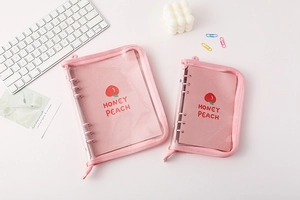 Detail of pink transparent PVC A5 A6 binder covers with peach pattern inner pages