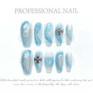 Detailed view of sky blue marble press-on nails with silver chain and cross ornaments