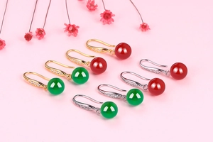 Macro detail of S925 silver drop earrings with red and green chalcedony and diamonds