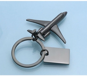 Detailed close-up of a gun-grey metal aircraft keychain with a rectangle pendant