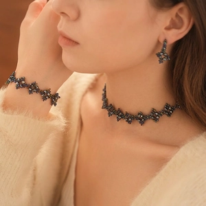 Elegant beaded choker and bracelet set featuring dark faceted crystal flower charms