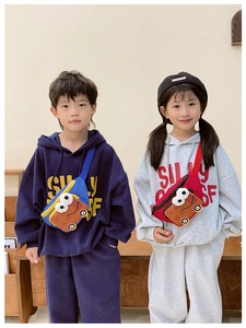 Close-up of kids cartoon bus crossbody bags in blue and red with 3D eye details