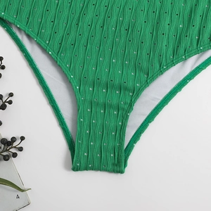Detailed macro shot of green pointelle fabric with wavy textures for a bikini