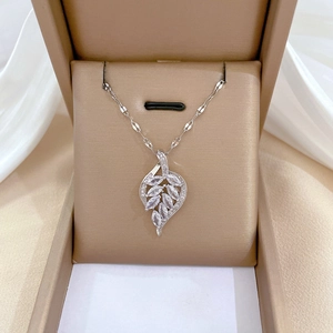 Silver titanium steel leaf pendant necklace with crystals in a beige jewelry gift box
