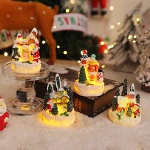 Set of 4 LED resin Christmas figurines featuring Santa Claus, snowman and snowy cottages