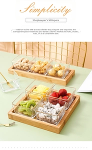 Close-up of square glass snack bowls with gold rims on a natural bamboo serving tray