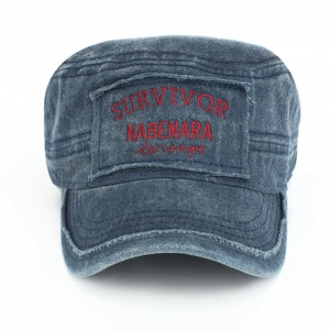 Close-up front view of vintage washed denim flat-top military cap with red embroidery