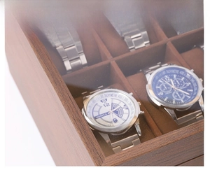 Detail view of the wooden watch box with soft velvet slots and a clear window